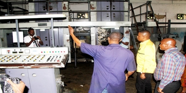 TGL printing press engineer Christian Ngwapaula (L) explains toCCMSecretaryforIdeology and PublicityShaka Hamdu Shaka on the printing operations   of newspapers. Looking on (R) is Nipashe Weekend Editor Epson Luhwago.